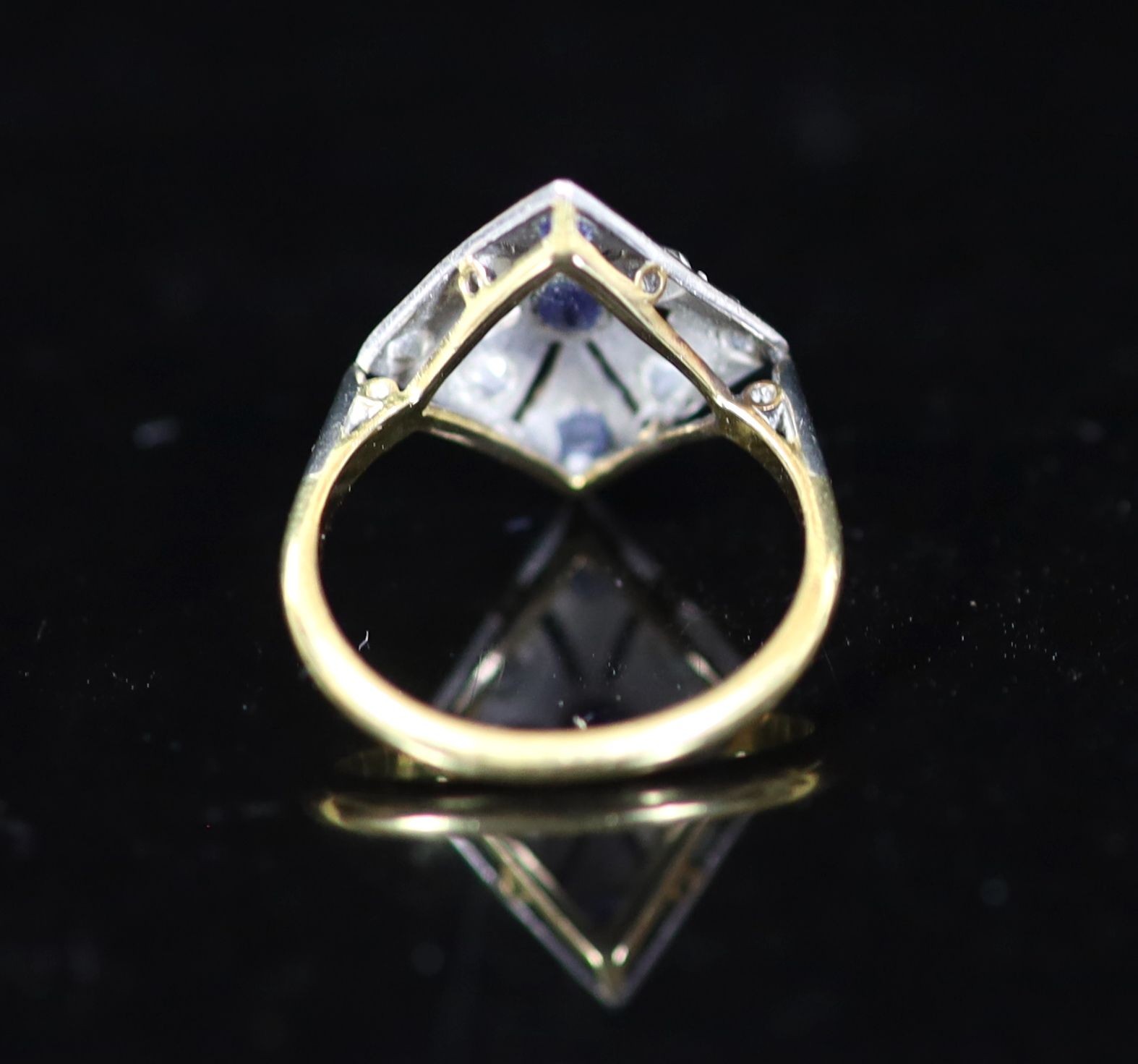 A 1920's/1930's 18ct gold and platinum, millegrain set sapphire and diamond pierced diamond shaped dress ring